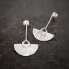 silver earrings with geometric patterns