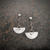 silver earrings with geometric patterns
