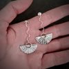 silver earrings with geometric patterns