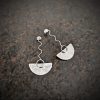 silver earrings with geometric patterns