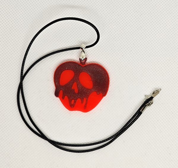 glow in the dark red apple with melting black holographic skull pendant