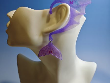 Purple mermaid ear with butterfly sequins on a mannequin