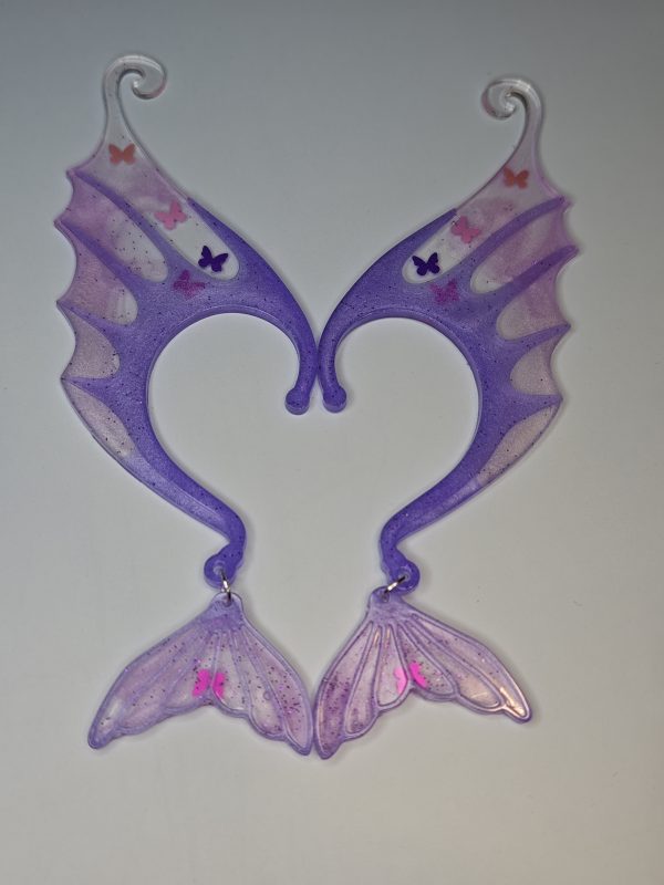 urple mermaid ear with butterfly sequins  with a mermaid tail.