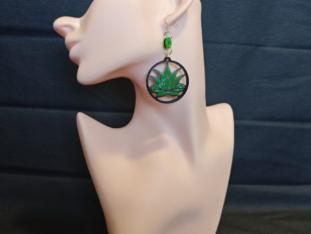 A green lotus flower in earring form