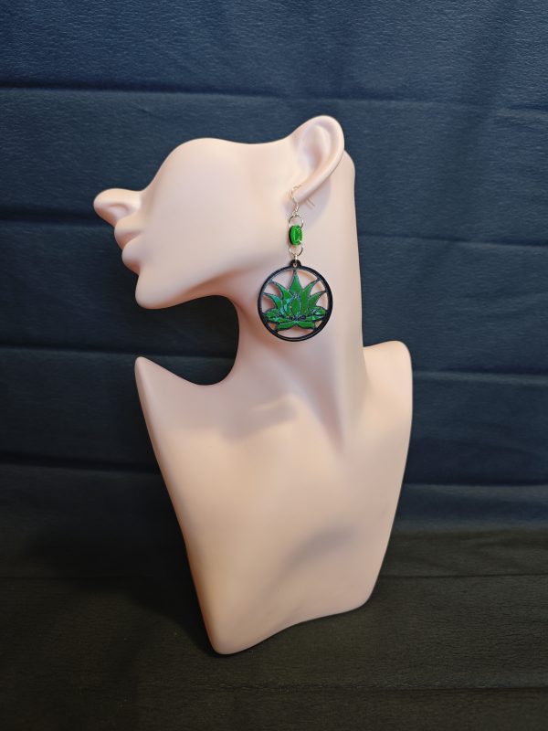 A green lotus flower in earring form
