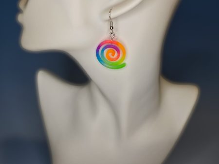 rainbow colored spiral shaped resin earring on a mannequin