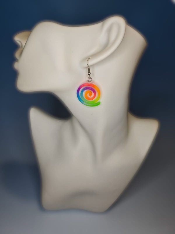 rainbow colored spiral shaped resin earring on a mannequin