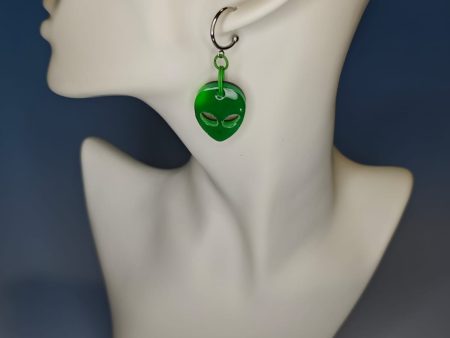 green alien earrings on a mannequin
