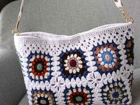 White granny square crochet bag with magnetic closure and felt lining